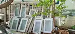 Neem based Windows with Iron Grills and Aluminium Panels with Glass