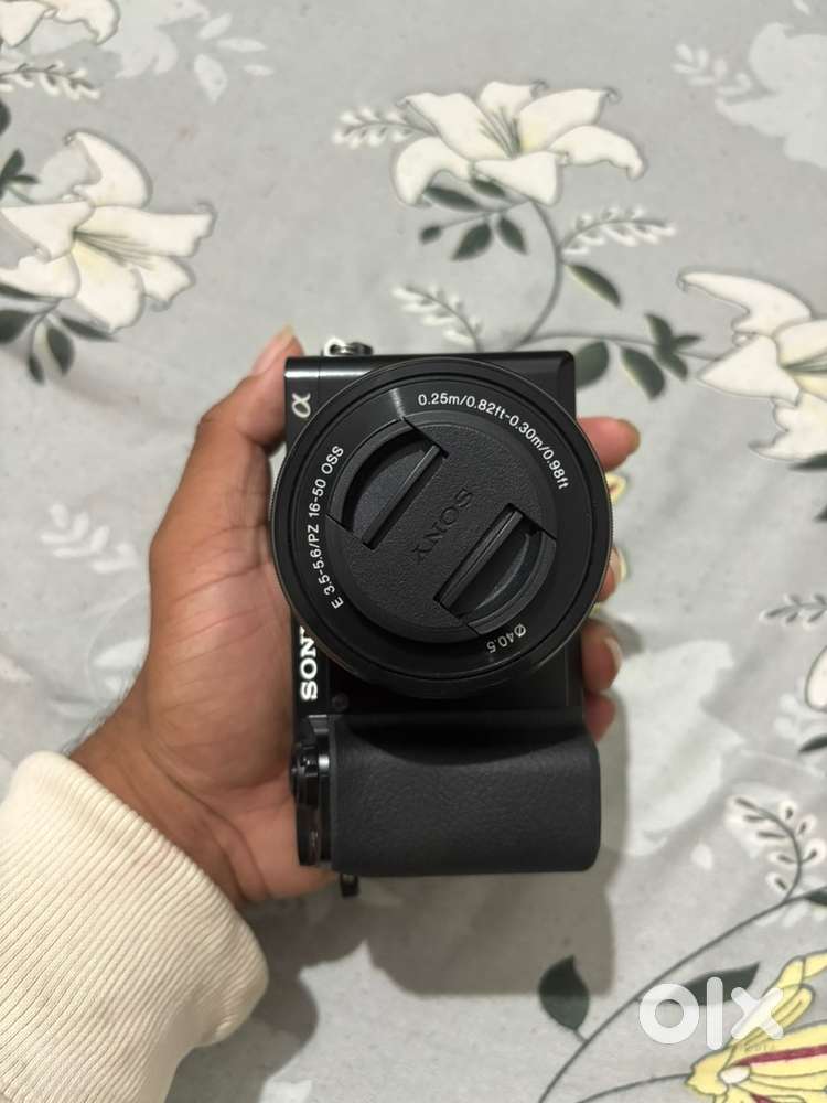 Sony a6100 with 16-50 oss lens and 3 batteries and a charging adapter