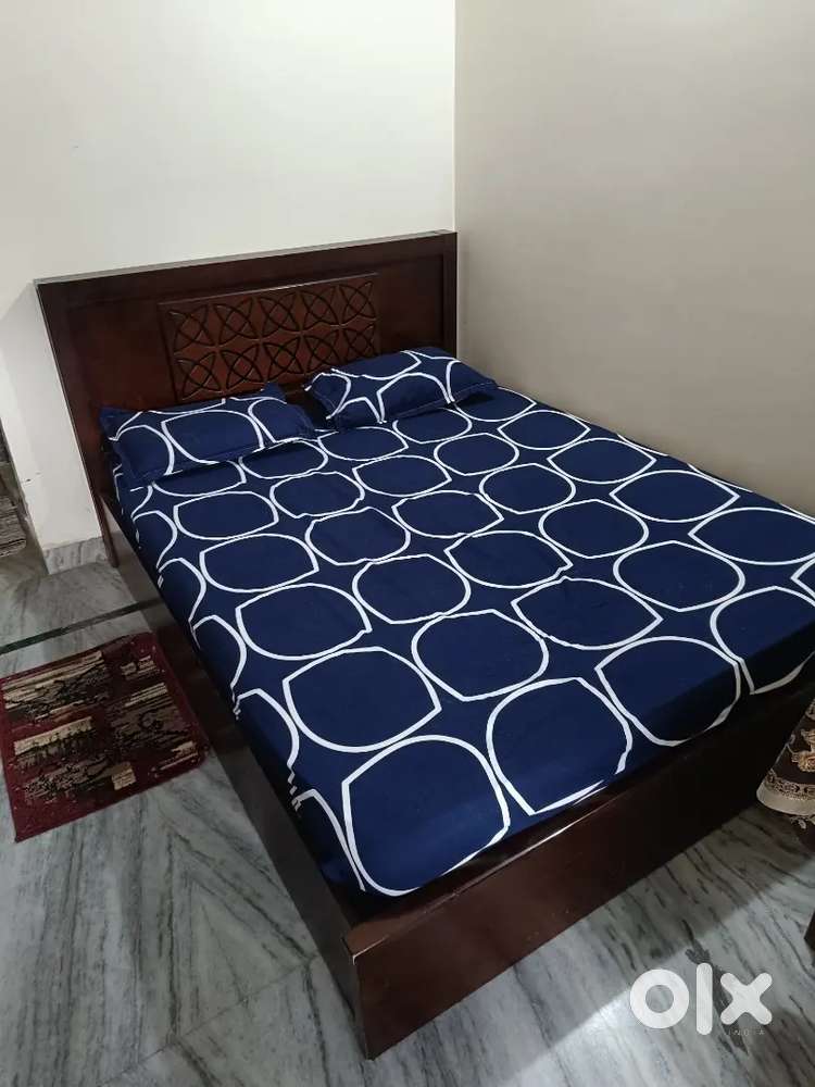 Bed and book shelf with premium mattress