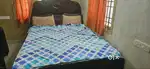 Wooden cot with mattress