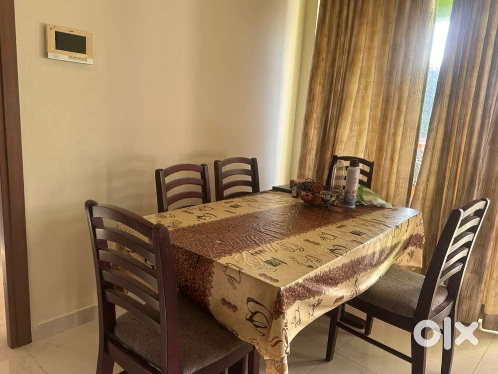 Sparingly used wooden dining table with 6 chairs for immediate sale