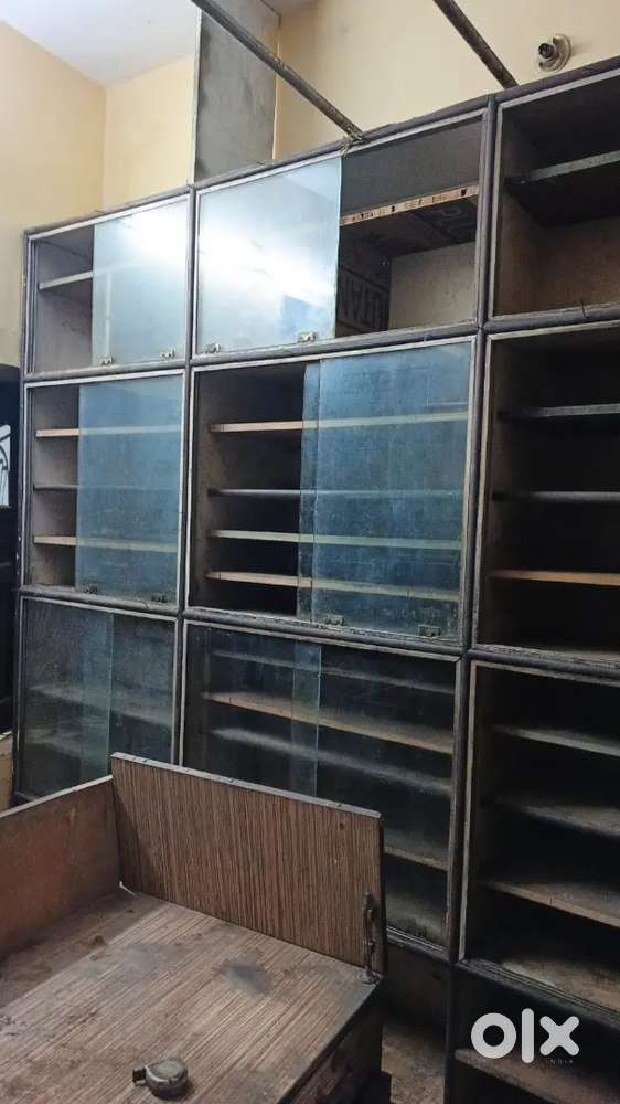 racks on 3 walls, counter & computer table