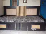 King-Size Sofa cum Bed with storage and four stylish wooden chairs