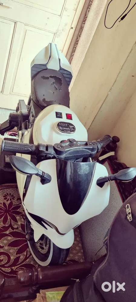 White nd with black color Kids battery bike