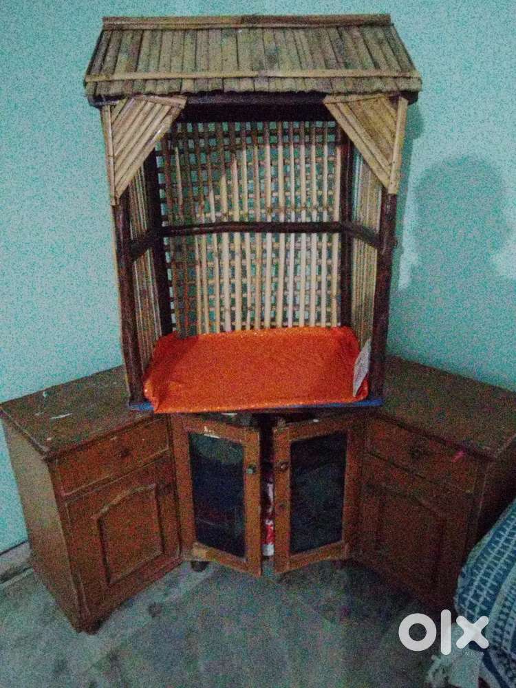 An angular corner cabinet with decorative cottage