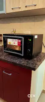LG 28 L Convection Microwave Oven, model in black floral design.