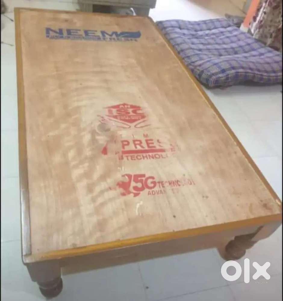 One wood cot One table and one chair