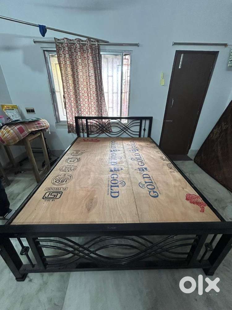 One queen size bed with two plywood and one wooden table