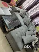 L shape sofa with table and puffy