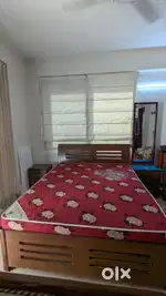 Queen size bed with side tables and dressing table
