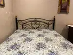 Wrought iron storage bed with mattress.