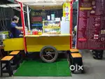 Food cart  ,yellow colour Honda bike setting.