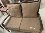 Two seater solid wood sofa with cushions