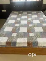 A wooden bed with mattress