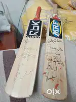 Cricket bats signed by Dhoni Raina and many others
