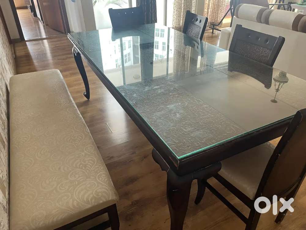 Eight seater table with five chairs and three seat bench.