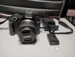canon r50 with 18-45 mm lens and battery and charger included