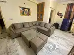 L shape sofa with puffy with center table