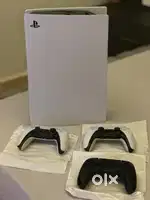 Playstation 5 with three controllers and charging dock