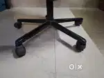 Office chair with minor damage to one of it's arm rest.