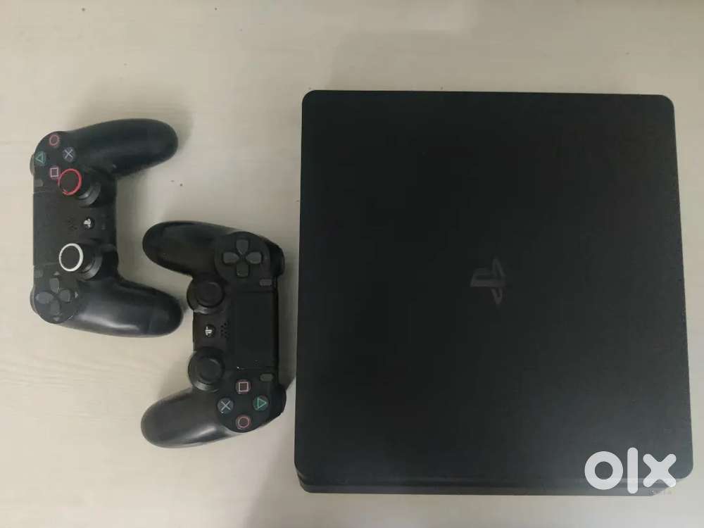 PlayStation 4 Slim 1TB with two controllers and 4 games