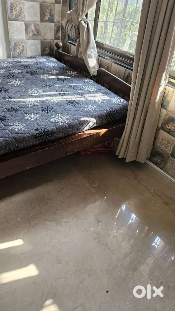 A wooden bed, crafted from pure wood, 6 by 4 feet, and a mattress.