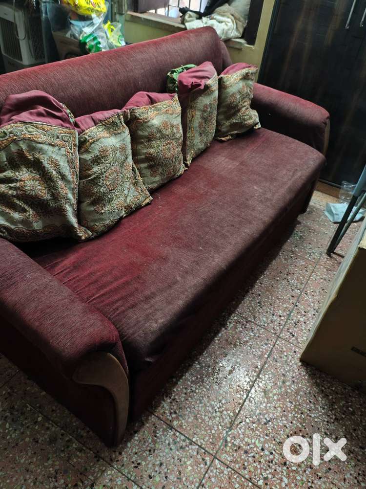 A sofa cum bed is there in a working condition