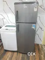 Whirlpool double door refrigerator and Samsung top load washing machin