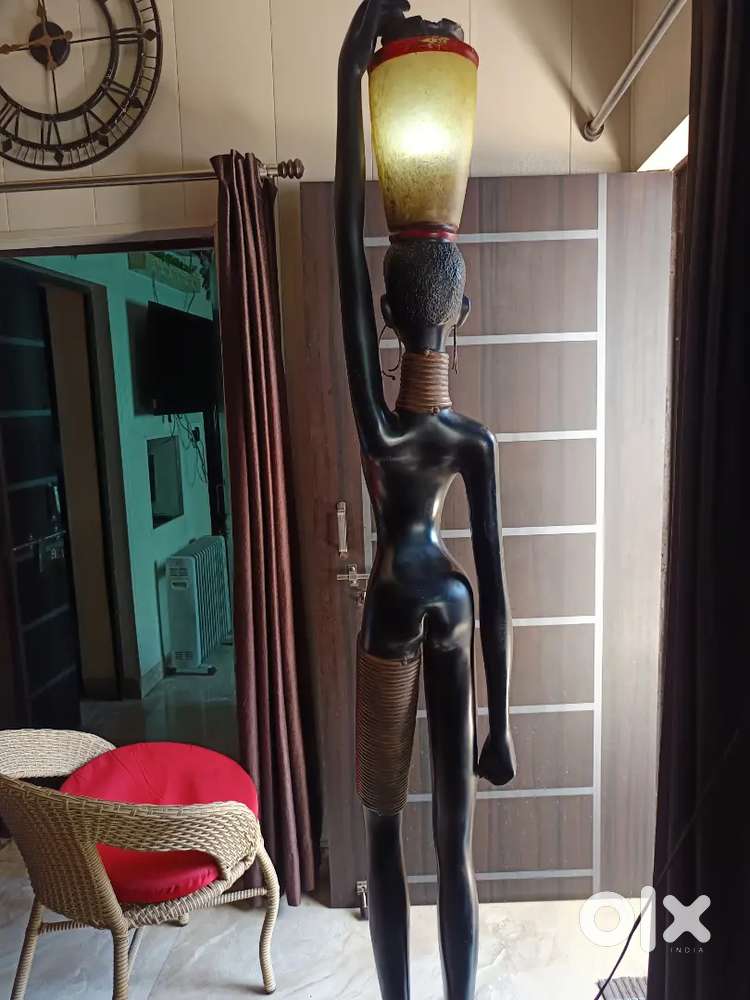 6 foot long statue with light on head