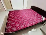 wooden cot with bed and dinning table with 4 chairs