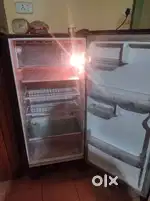 Old LG Refrigerator and Brand New Sofa