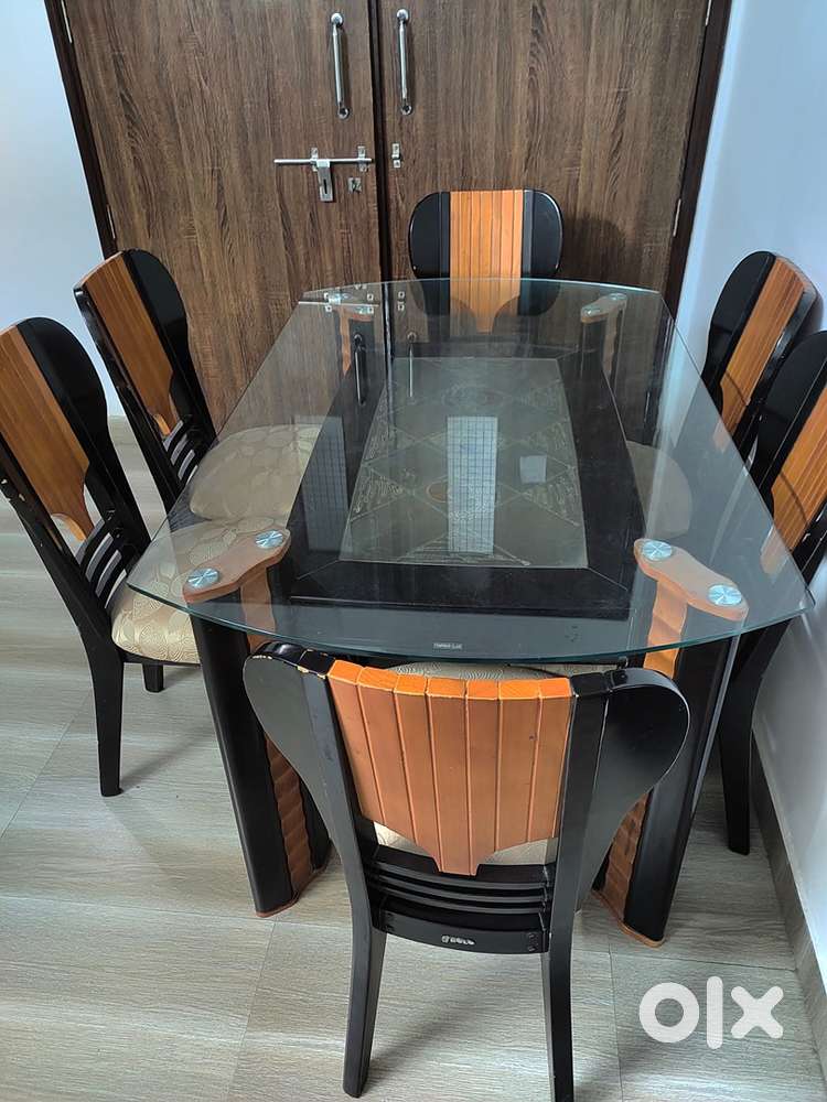 6 seater wooden dining table with glass top