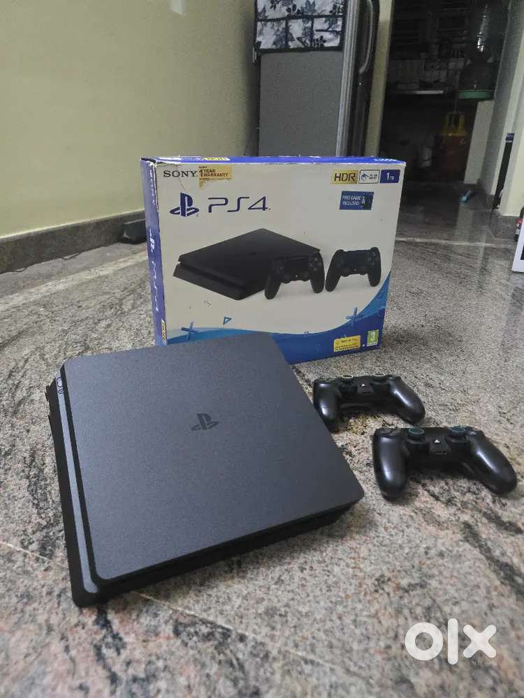 PS4 Slim 1TB – With 2 Controllers + Games