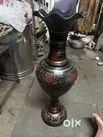 Its an brass metal vase and in good condition