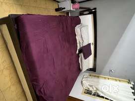 Storage Bed with mattress and dressing table in white color.