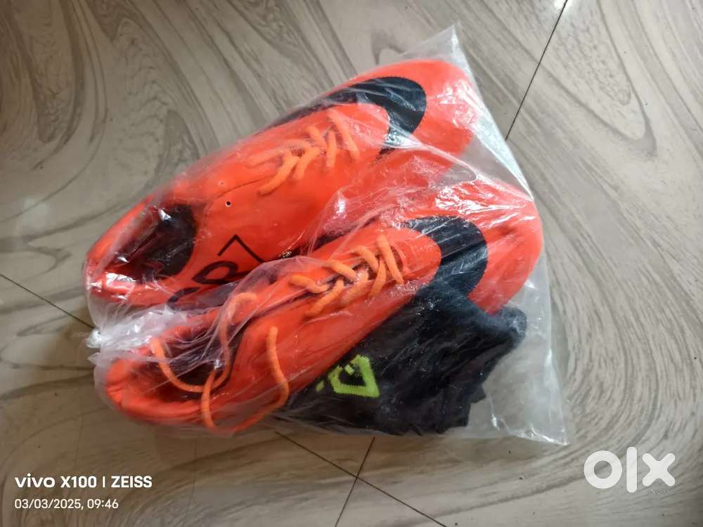 Unused football boot with socks