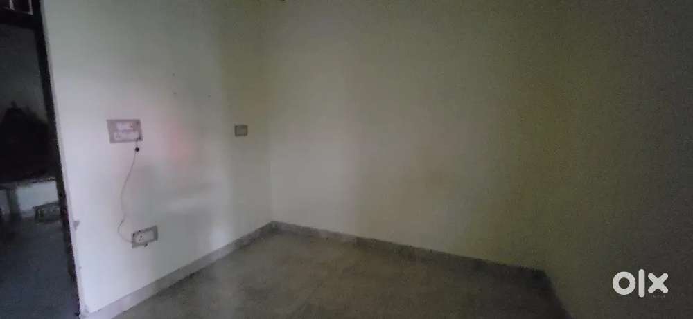 Infront of guest house beside a temple  a green color house