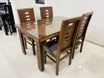 Dinning table made from modern materials like glass or teak wood