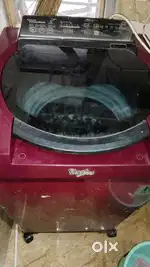 A cherry red colour whirlpool washing machine