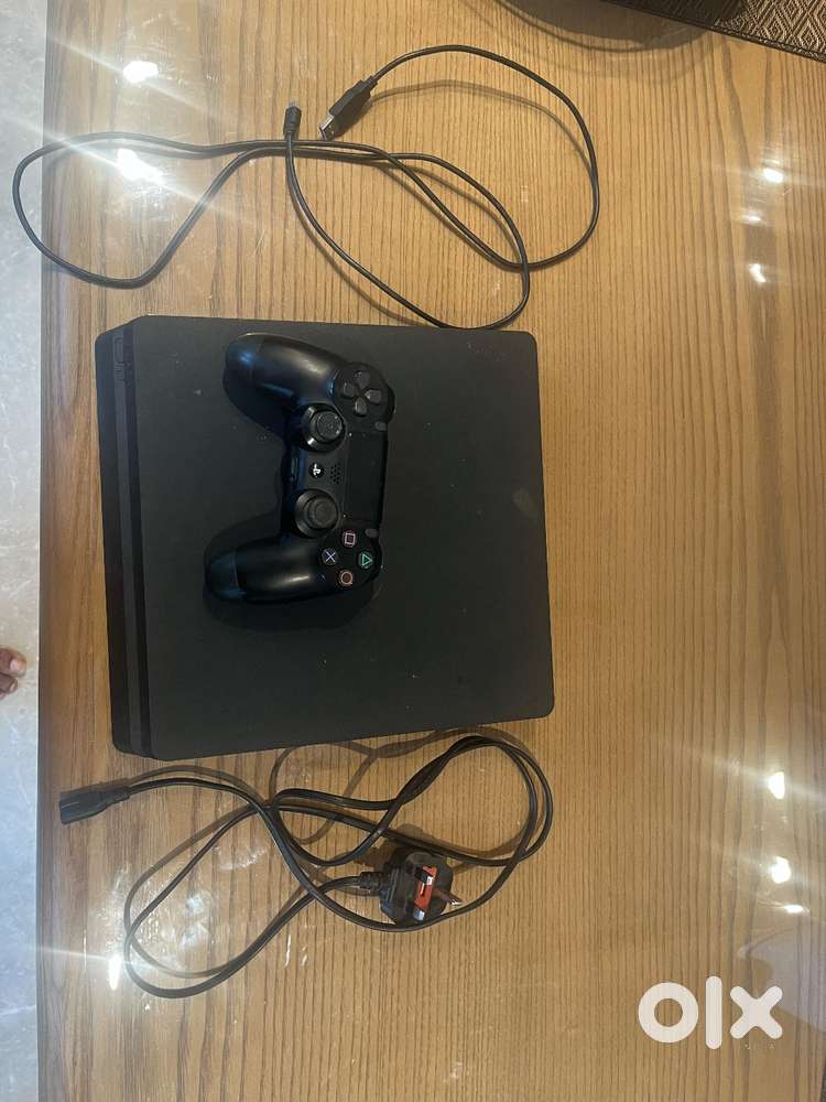 PS4 Slim (500GB) with 1 DUALSHOCK 4 controller (2020) and 5 game CDs