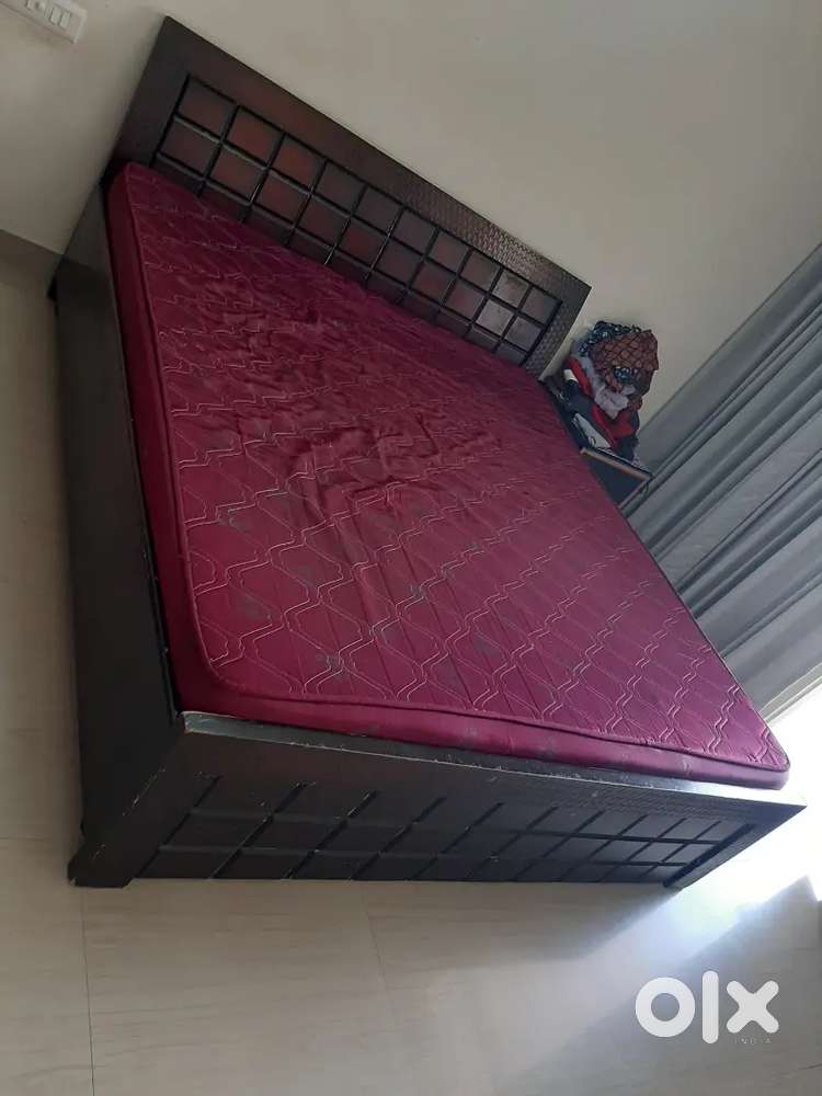 Wooden bed with mattress
