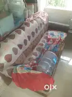 Old three seater wooden foam sofa