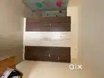 Wooden cots and particle board wardrobes
