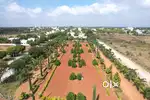 CLOSE TO HIGHWAY FACING PLOT IN WELL DEVELOPED GATED COMMUNITY