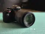 Nikon D3400 DSLR camera with zoom and prime lenses