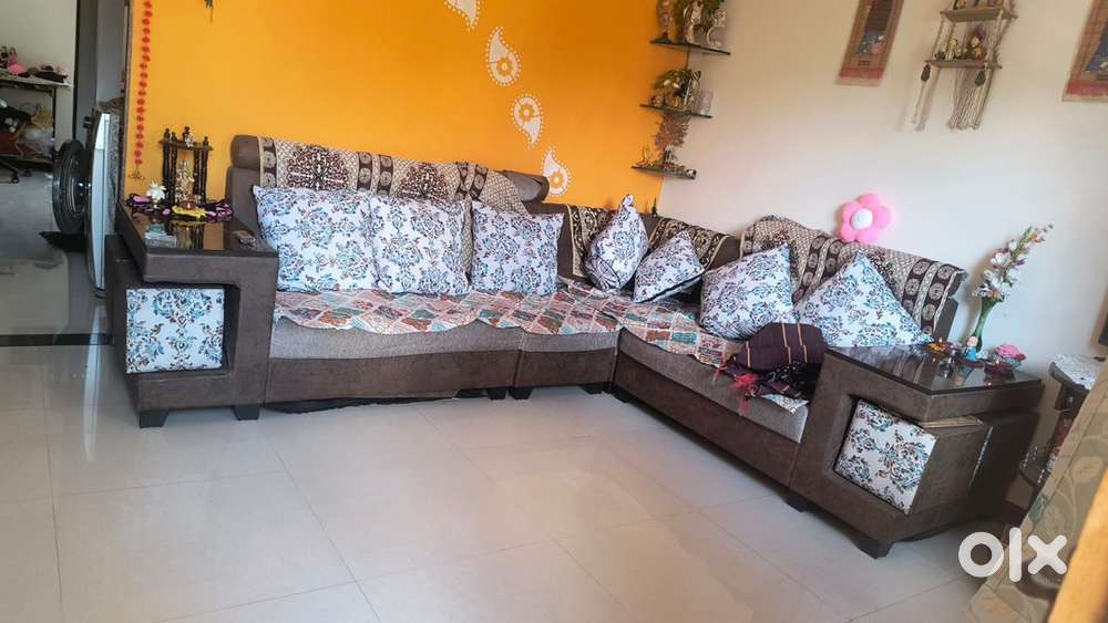 L shaped sofa with stools and pillows