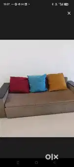 Gently used sofa cum bed with colourful 3 big cushions