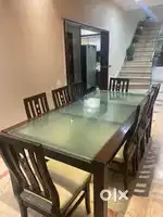 Elegant Wooden Dining table with glass top and  leather cushion chairs