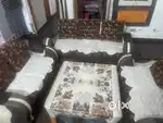 7 seater wooden sofa with big cushions.