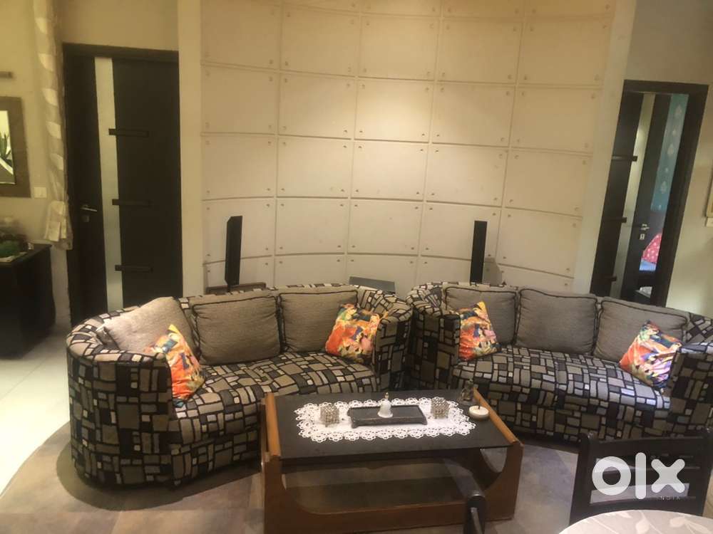 Five seated sofa in two pieces with glass table